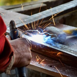 a person welding metal on a workbench