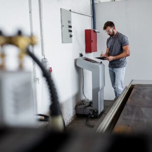 man inspecting plasma cutter