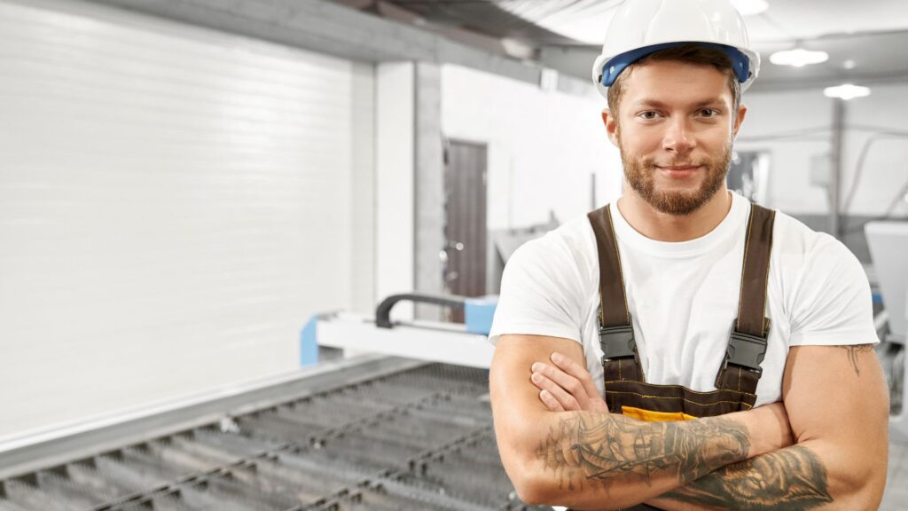 employee standing by plasma cutter