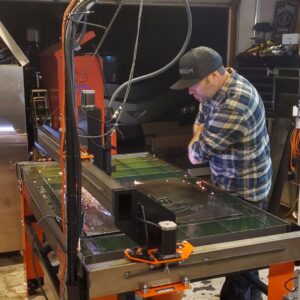 man working with CNC plasma cutting machine